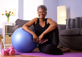 Smiling older woman with exercise equipment