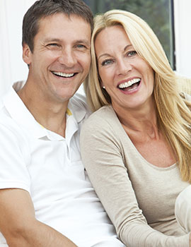 Smiling middle-aged couple at Fairfax dental office