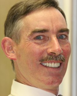 Older man with mustache and perfectly aligned teeth