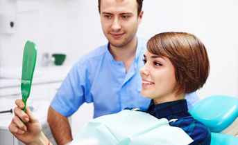 Woman looking at smile in mirror