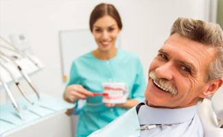 Smiling senior man in dental chair