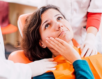 woman with toothache at dentist