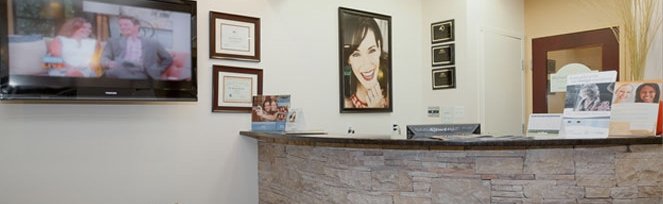 Dentist Michael K. Bassiri standing in his Fairfax dental office