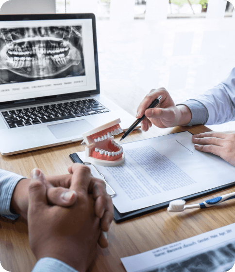 man pointing to teeth with patient