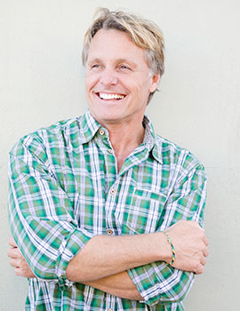 Man with perfect teeth posing in Michael K. Bassiri's Fairfax dental office